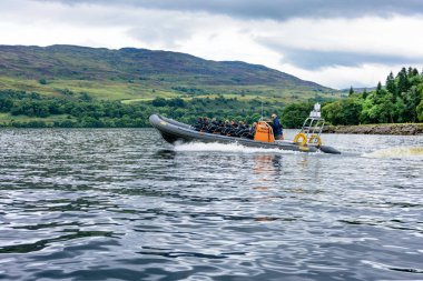 Turistler speedboating Loch Ness bir kaburga teknede