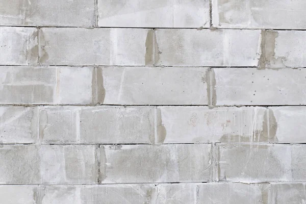 Beton bloklardan yapılmış tuğla duvar. Beton blok duvar pürüzsüz arkaplan ve doku.