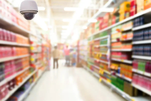 Überwachungskameras auf dem abstrakten unscharfen Foto eines Ladens im Kaufhaus-Bokeh-Hintergrund — Stockfoto