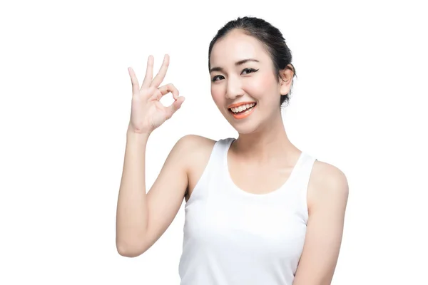 Mutlu Asyalı genç kadın güzel smile beyaz arka plan üzerinde ok hareketi ile — Stok fotoğraf
