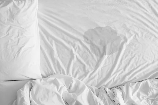 Pee on a bed mattress,Bedwetting sleep enuresis in Adults or baby concept,selected focus at wet on the bed sheet — Stock Photo, Image