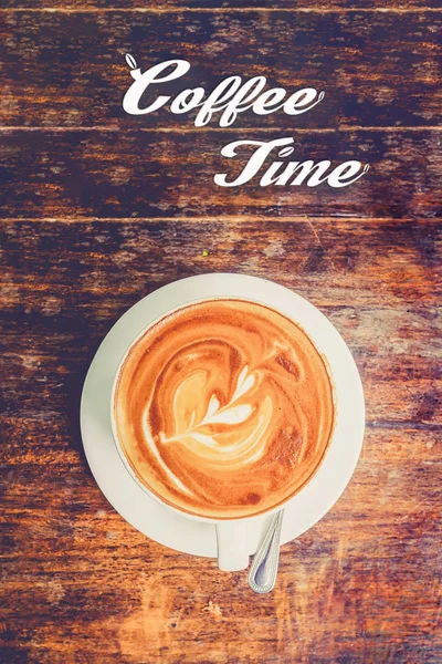 Latte art:Coffee time concept with hot coffee in white cup on wooden table