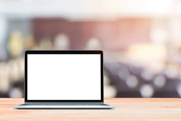 Laptop with blank screen placed on white wooden table in blurred people in Blurred conference room — Stock Photo, Image