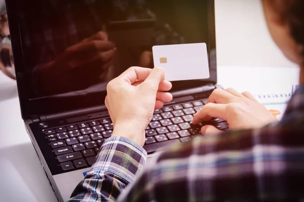 Male hands holding credit card typing numbers on computer keyboard :online shopping concept — Stock Photo, Image