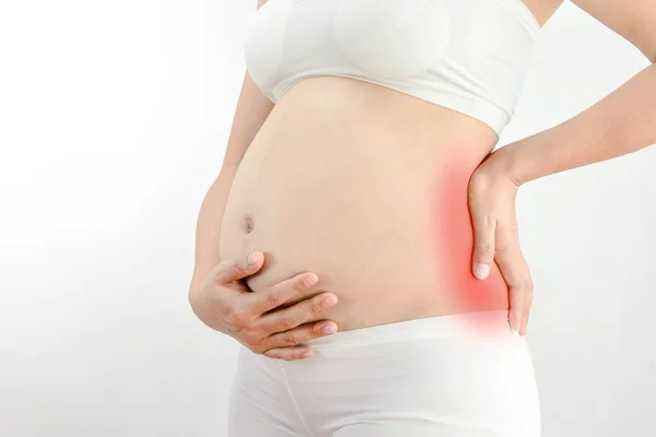 Pregnant woman with a strong pain massaging her back :Pelvic pain or lower back pain in pregnancy — Stock Photo, Image