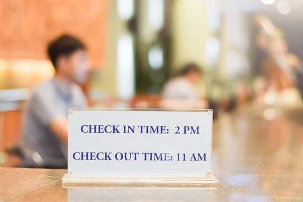 Check in and Check out time at Hotel Reception Counter Close up night time