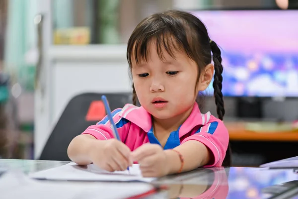 Little preschool girl making homework at home with serious face and unhappy — 스톡 사진