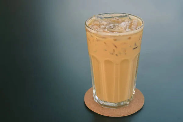 Cold coffee in glass on the dark table in cafe — Stock Photo, Image