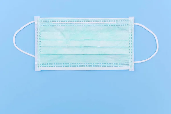 Medical face mask, Medical protective mask on blue background. Disposable surgical face mask cover the mouth and nose. protect Healthcare and medical concept.