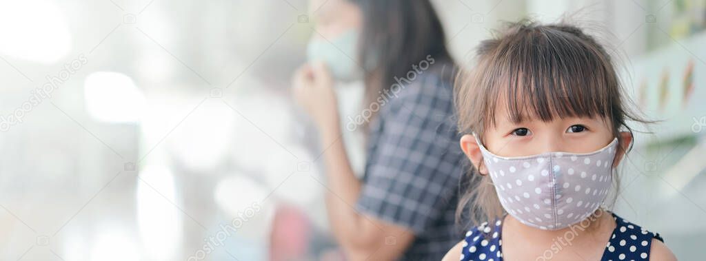 Little girl has fabric mask protect herself from Coronavirus,New Normal lifestyle after COVID-19 outbreak child leave the house with mask on her nose for safety outdoor activity,illness or Air pollution