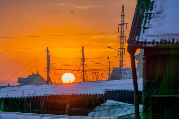 Winter sunset in the siberia on the background of power lines