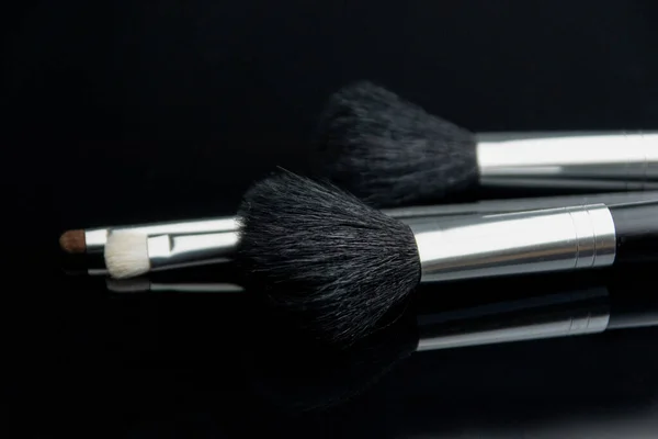 Make Brushes Lying Black Glass Table Photo Selectiv Focus Low — Stock Photo, Image