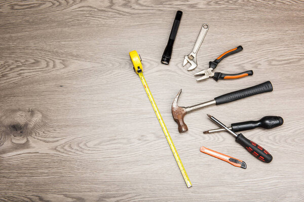 The repair tools is placed on the wooden table.