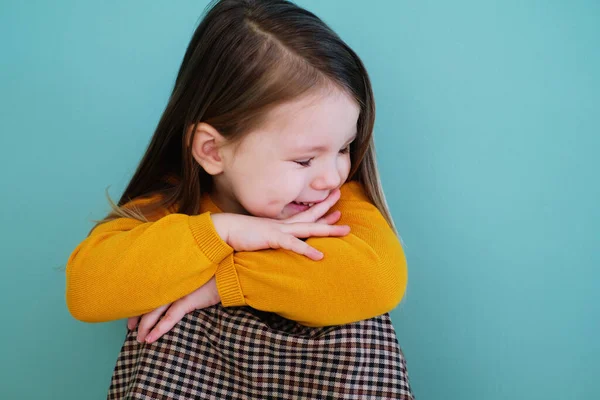 A young girl wearing a yellow shirt Stock Photo