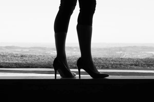 silhouette of woman legs with heels shoes