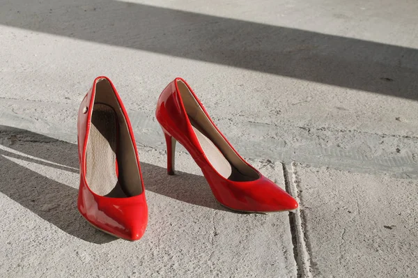 red heels shoes in an unfinished house