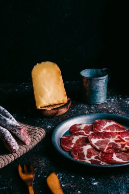 Klasik ahşap masadaki tipik İspanya peyniri ve sosisi çeşitleri. Koyun peyniri, fuet, sosis, sucuk. İspanyol yemeği. Metin için boş alan. Üst görünüm.