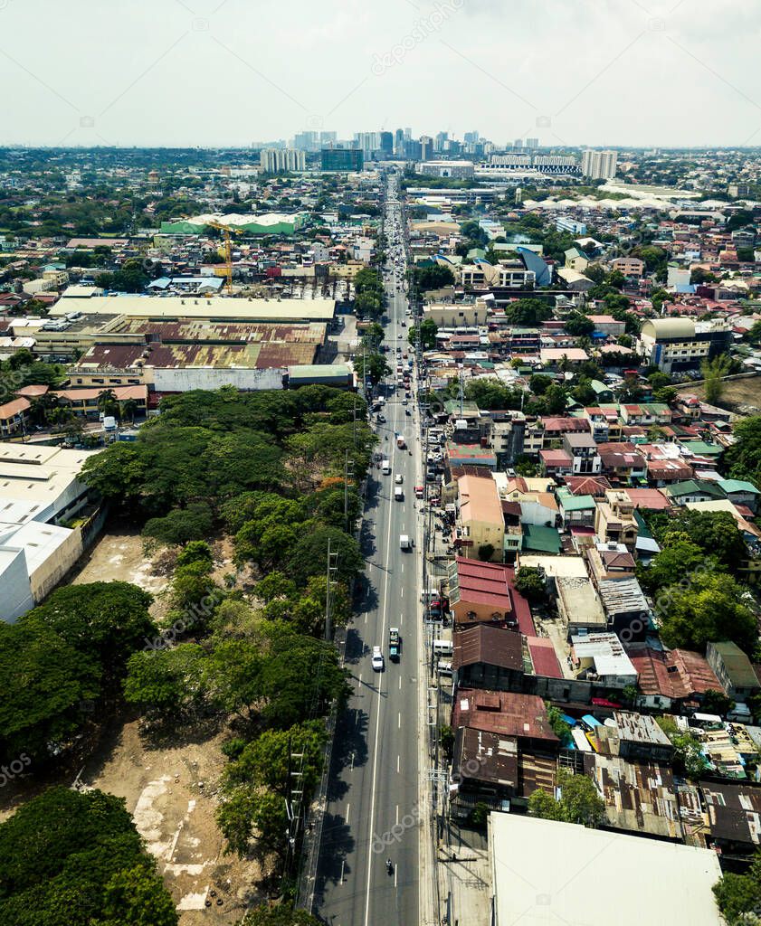 Las Pinas, Metro manila - May 2020: Aerial of Alabang Zapote Road in center, with Alabang skyline in background.