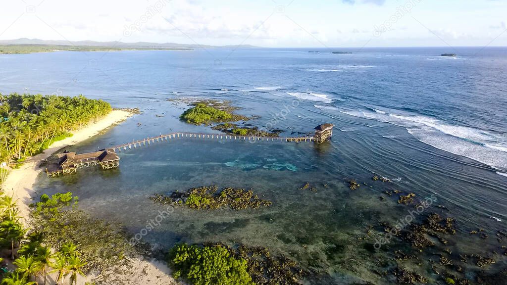 Aerial of boardwalk of famous Cloud 9 at late afternoon, General Luna, Siargao, Philippines.