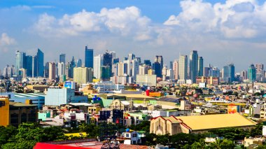 Paranaque, Metro Manila, Philippines - Jan 2016: Baclaran Church with Makati Skyline in background. clipart