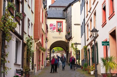BERNKASTEL- KUES, RHINELAND-PALATINATE / GERMANY - OCTOBER 18. Tourists on the street of the medieval town on the  Moselle river clipart