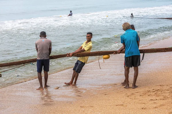 GALLE / SRI LANKA - NOVEMBRO 29, 2019: Pescadores puxam uma rede com peixes do mar — Fotografia de Stock