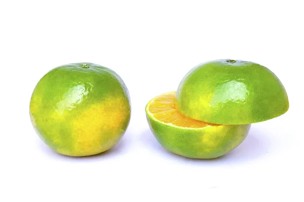 Green oranges and sliced isolated on a white — Stock Photo, Image