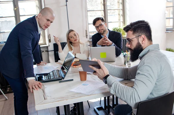 Team of business people and designers in the office, working on new projects and discussing new ideas. Young businessman startup concept.