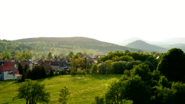 A small village in a hilly area on a bright day - top view — Stock Video