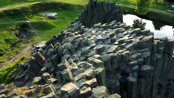 La parte superior de una roca de basalto columnar cerca de un lago .- vista superior — Vídeos de Stock