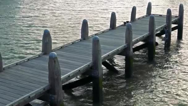 A jetty on a turbulent sea surface — Stock Video