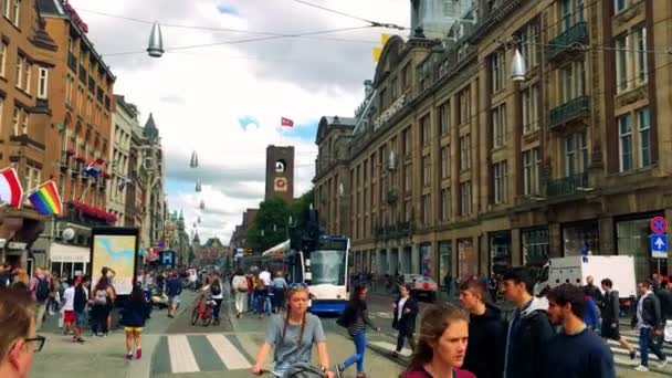 People get in a tram on a busy quaint street — Stock Video