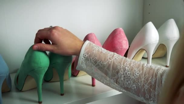 Vrouw kijkt naar schoenen op de planken — Stockvideo