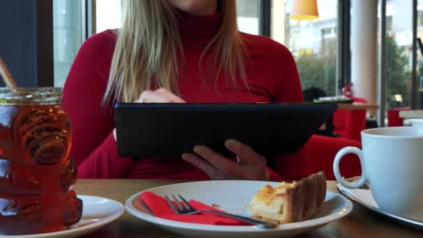 Woman in a cafe and works on a tablet — Stock Video