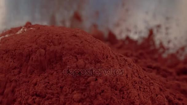 Cocoa powder is poured into a bowl of flour — Stock Video