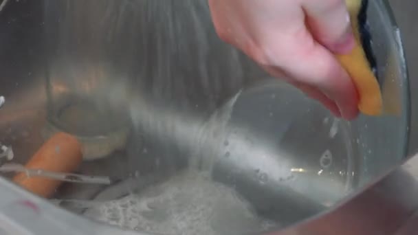 Женщина моет посуду после выпечки — стоковое видео
