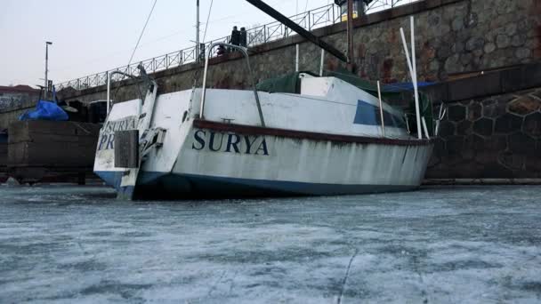 Barco estacionado en un muelle en un río congelado — Vídeos de Stock