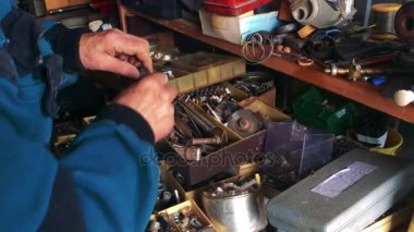 Bir tamirci kameraya bir bileşeni gösterir