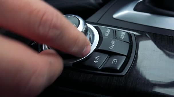 Um homem vira uma maçaneta e pressiona botões na caixa de mudança de velocidades de um carro — Vídeo de Stock