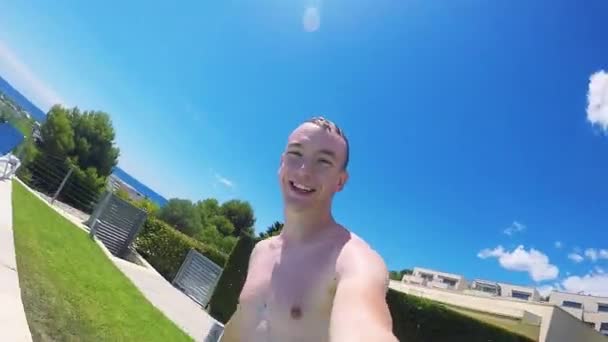 Man jumps into the swimming pool with gopro camera — Stock Video