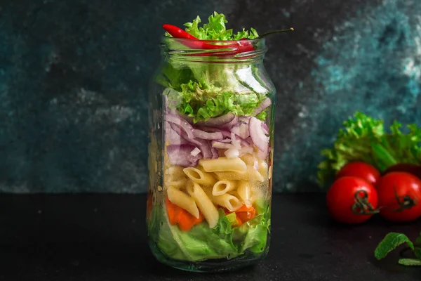 healthy salad in a jar (vegetable snack pasta salad) menu concept. food background. top view. copy space