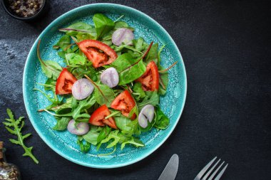 healthy salad (tomato, mix leaves, onions and other ingredients) vegan top, keto or paleo menu concept. food background. copy space