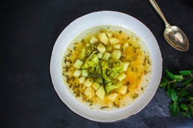 soup broccoli, broth and other vegetables (vegetarian first course) menu concept. background. top view. copy space