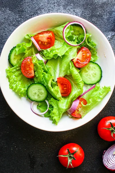 Healthy salad, leaves mix salad (mix micro greens, cucumber, tomato, onion, other ingredients). food background. copy space for text