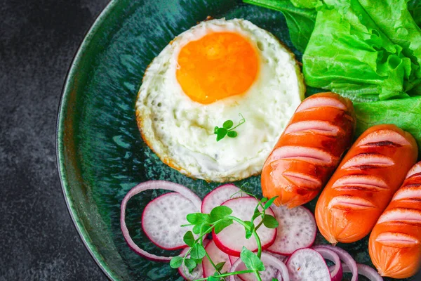 healthy breakfast, fried eggs sausages and vegetables Menu concept. food background. top view copy space for text keto or paleo diets