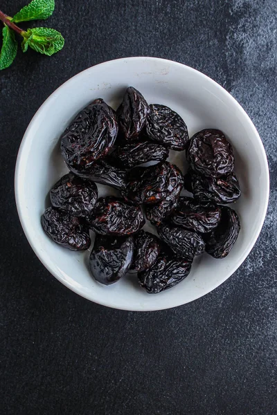 prunes, dried plums (tasty and healthy fruits) desiccated keto or paleo dietmenu concept. background. top view. copy space for text