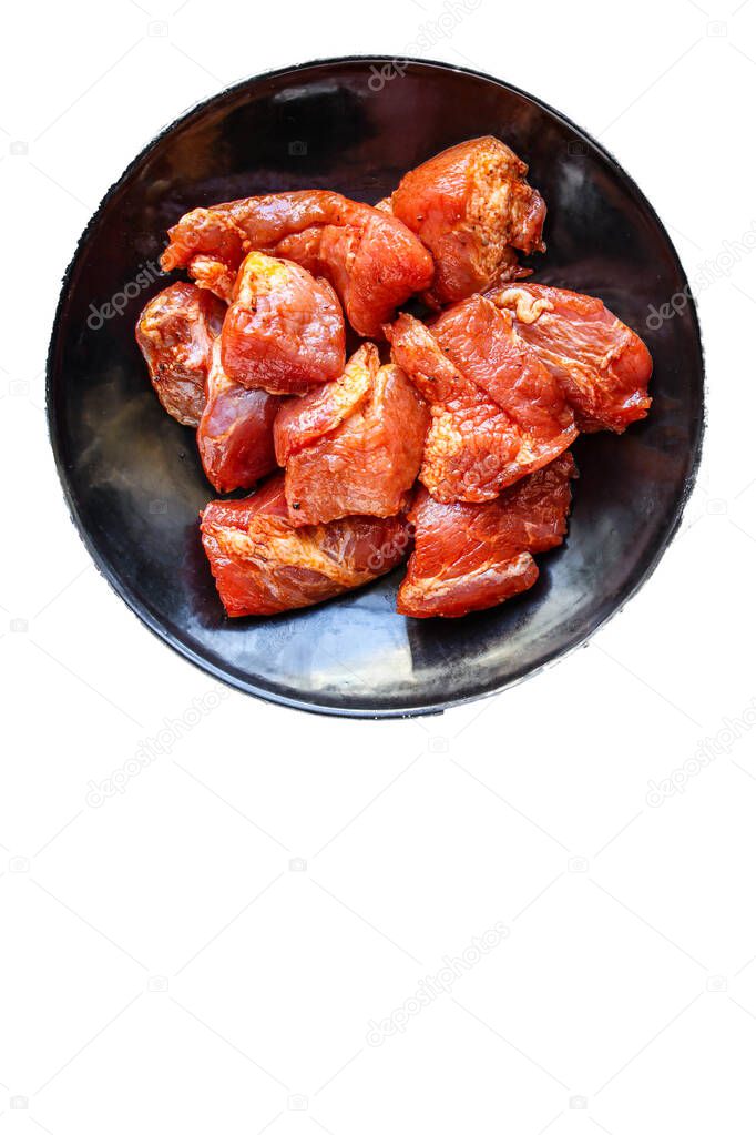 raw meat pork or beef in a plate on the table (preparing healthy food, marinade and spices paprika) menu concept background. top view. copy space for text