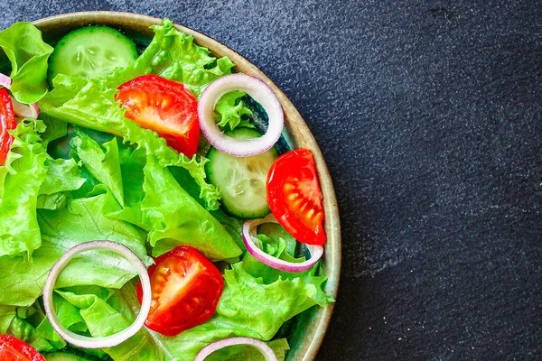 Healthy salad, leaves mix salad (mix micro greens, cucumber, tomato, onion, other ingredients). food background. copy space for text keto or paleo diet