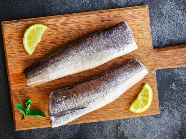 fish raw hake (set of ingredients). food background. top view. copy space ketogen or paleo diet pascarian