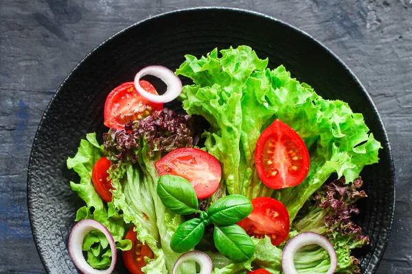 Healthy salad, leaves mix mix micro greens, cucumber, tomato other ingredients. food background. copy space